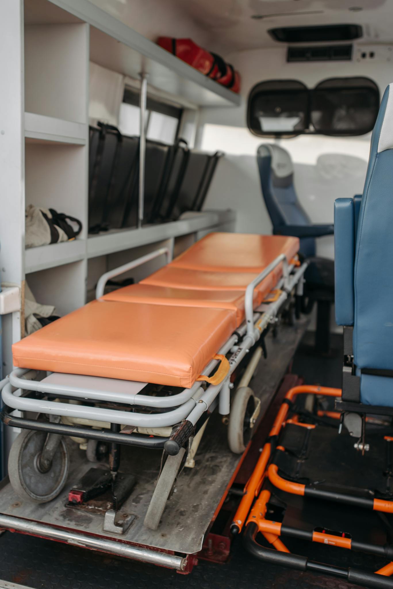 Detailed view inside an ambulance showing stretcher and medical equipment storage.