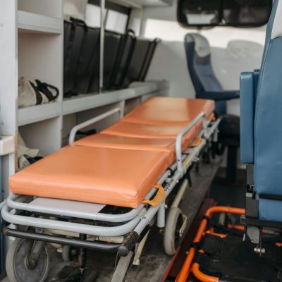 Detailed view inside an ambulance showing stretcher and medical equipment storage.