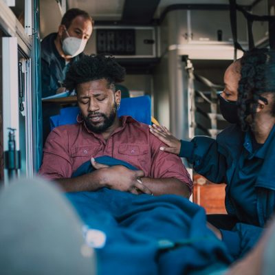 Paramedics provide emergency care to a patient inside an ambulance, ensuring timely medical attention.